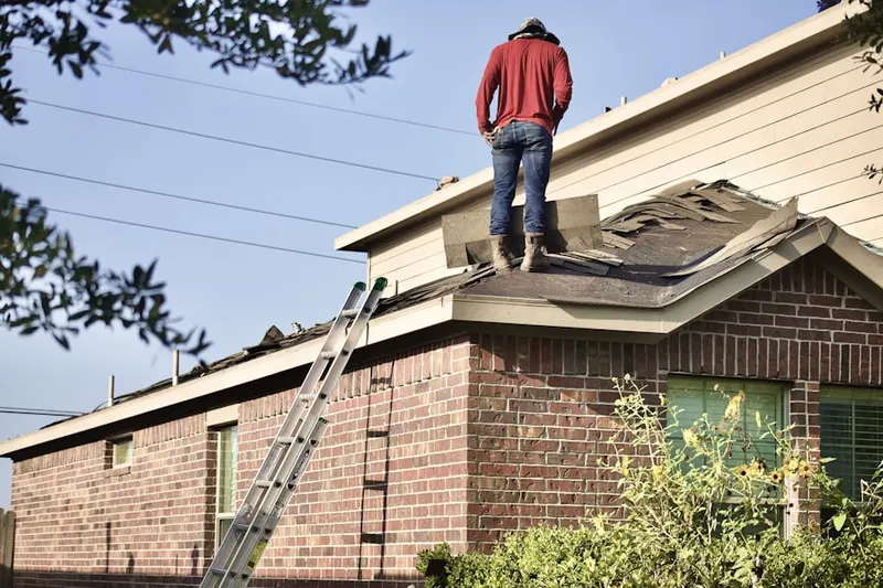 Professional roofer working on a residential roof in Stony Brook